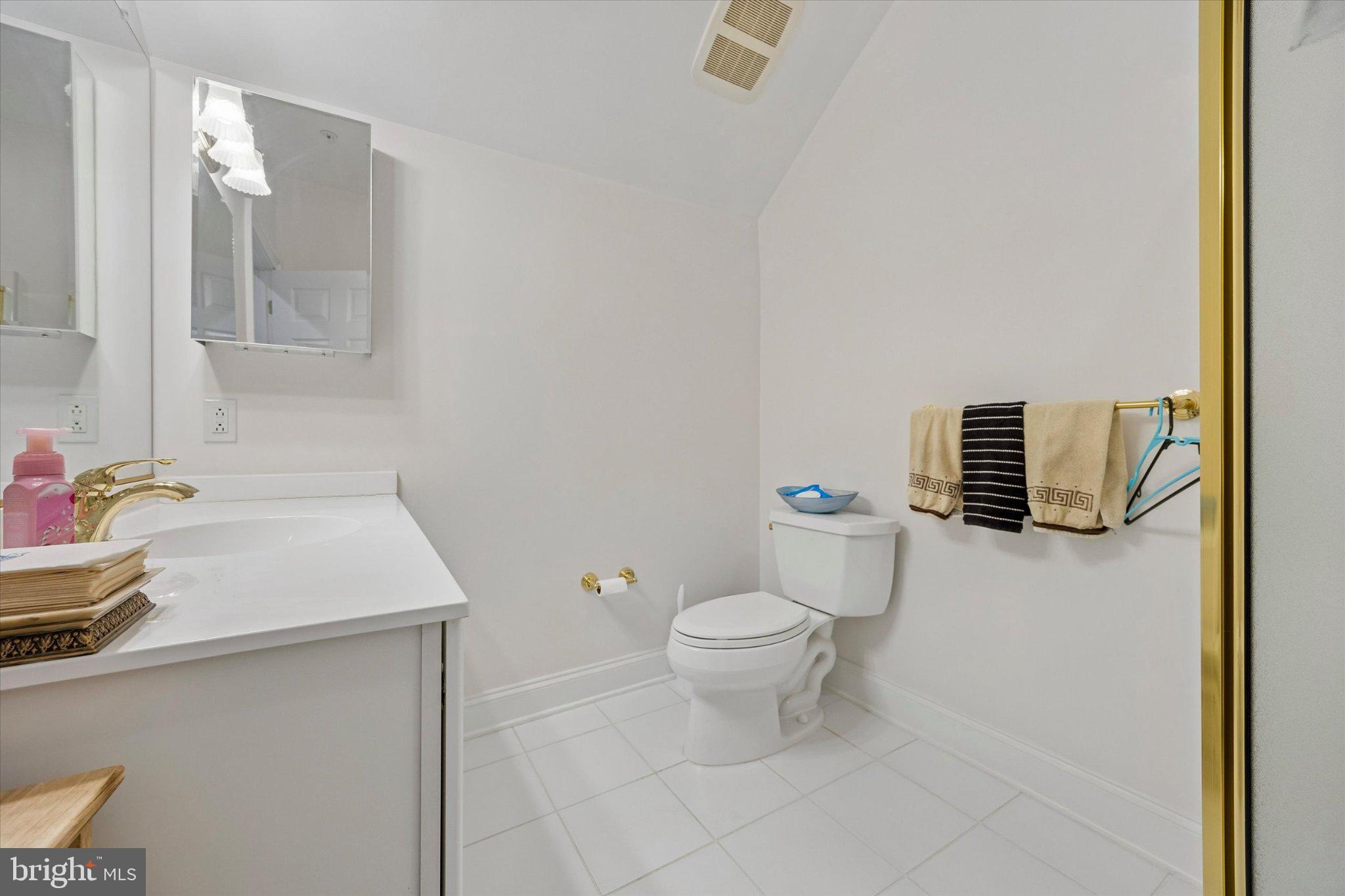 126 Bancroft Mills Road, Unit 14 Wilmington, DE 19806 - Photo 29 of 35 a bathroom with a sink toilet and mirror