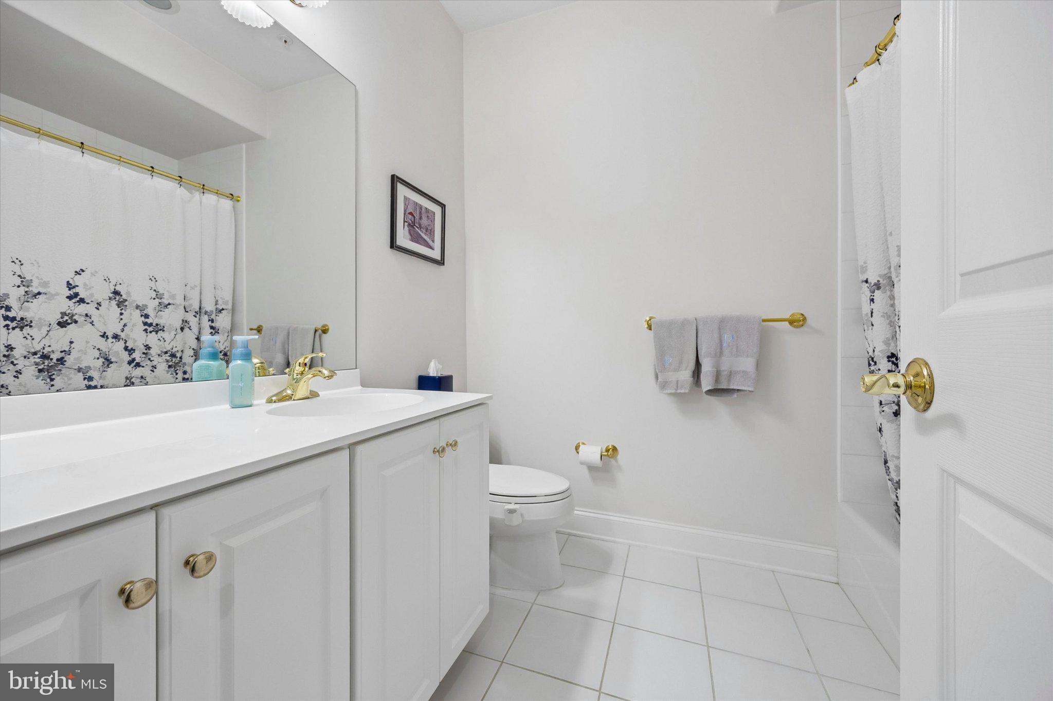 126 Bancroft Mills Road, Unit 14 Wilmington, DE 19806 - Photo 32 of 35 a bathroom with a sink toilet and shower