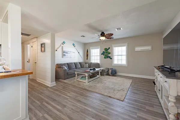 a living room with furniture and a wooden floor