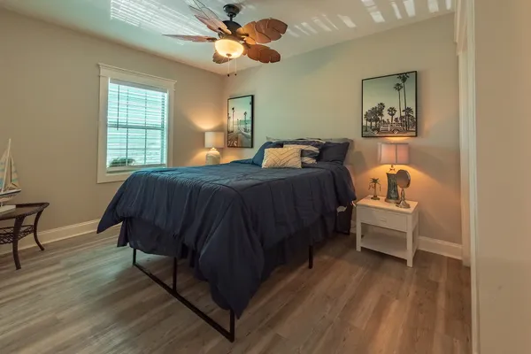 a bedroom with a bed and wooden floor