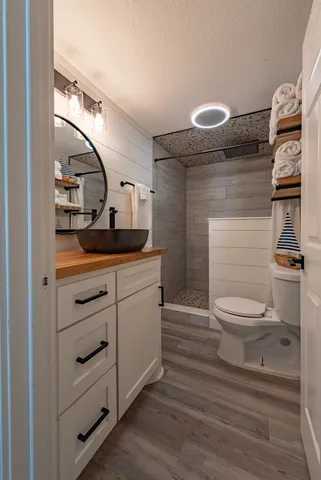 a bathroom with a toilet sink and mirror