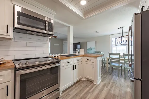 a kitchen with a stove oven and white cabinets