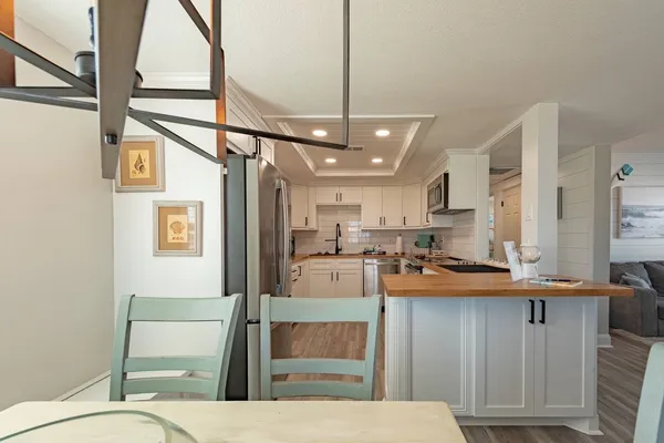 a kitchen with a refrigerator and a sink