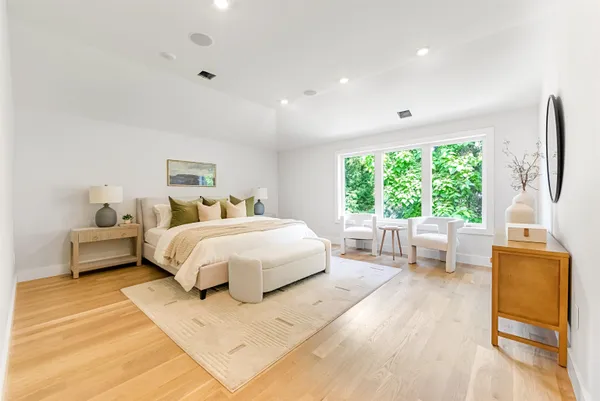 a bedroom with a large bed and a large window