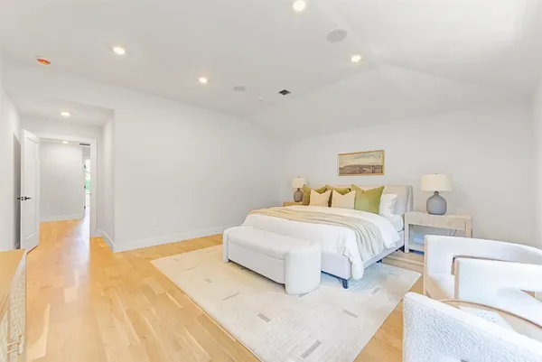 a spacious bedroom with a bed and a couch