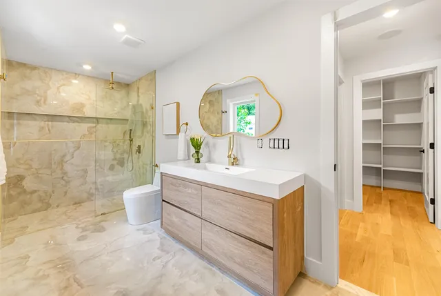 a bathroom with a sink mirror toilet and bathtub