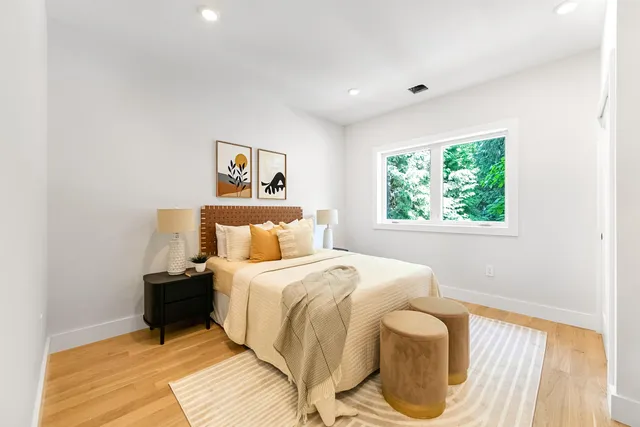 a bedroom with a bed and a window