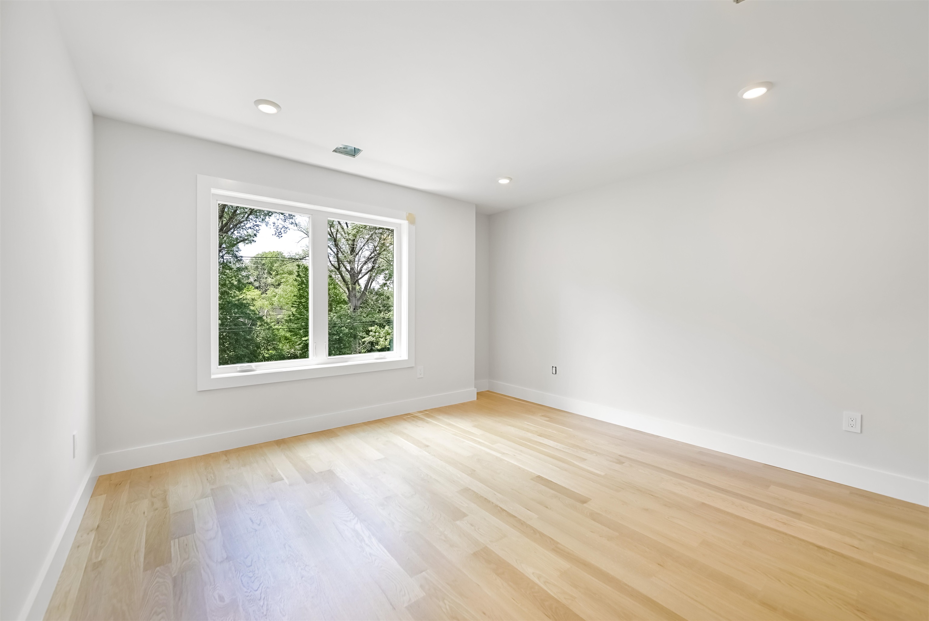 429 Riverside Avenue Rutherford, NJ 07070 - Photo 20 of 26 a view of an empty room with wooden floor and a window