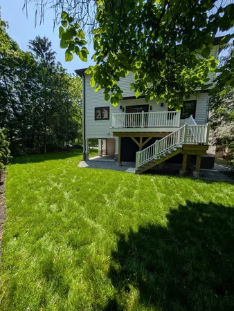 a view of a house with backyard and sitting area