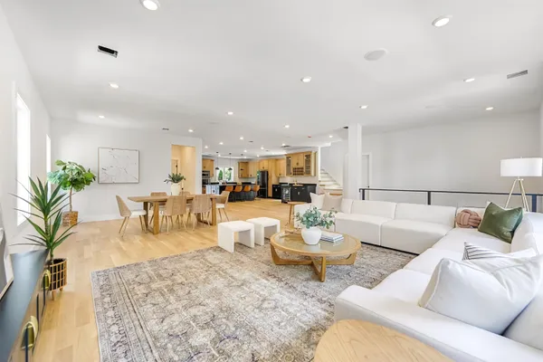 a living room with furniture kitchen view and a table