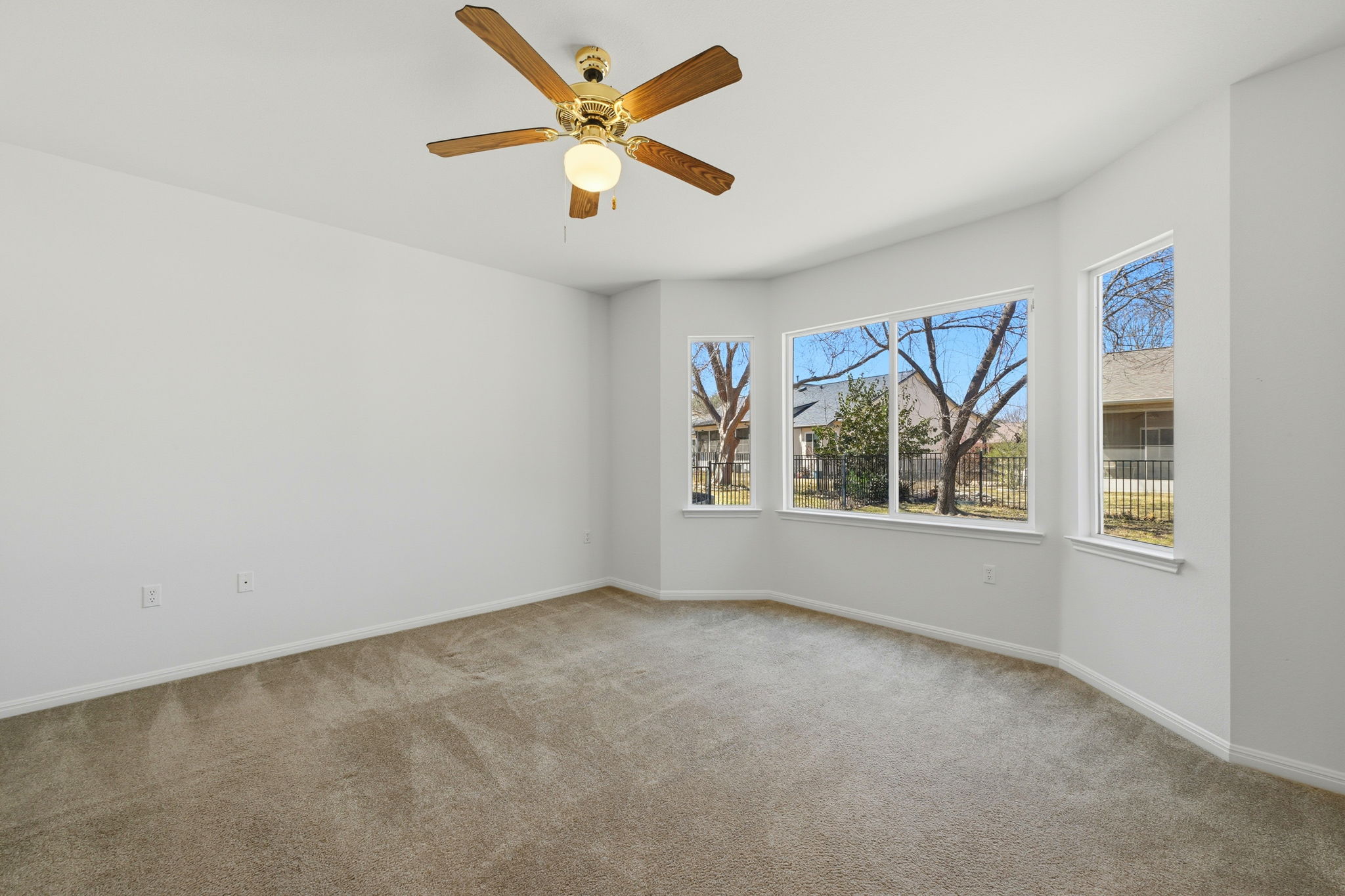 708 Texas Drive Georgetown, TX 78633 - Photo 12 of 27 Primary bedroom with lovely bay window looking out to shaded back yard.