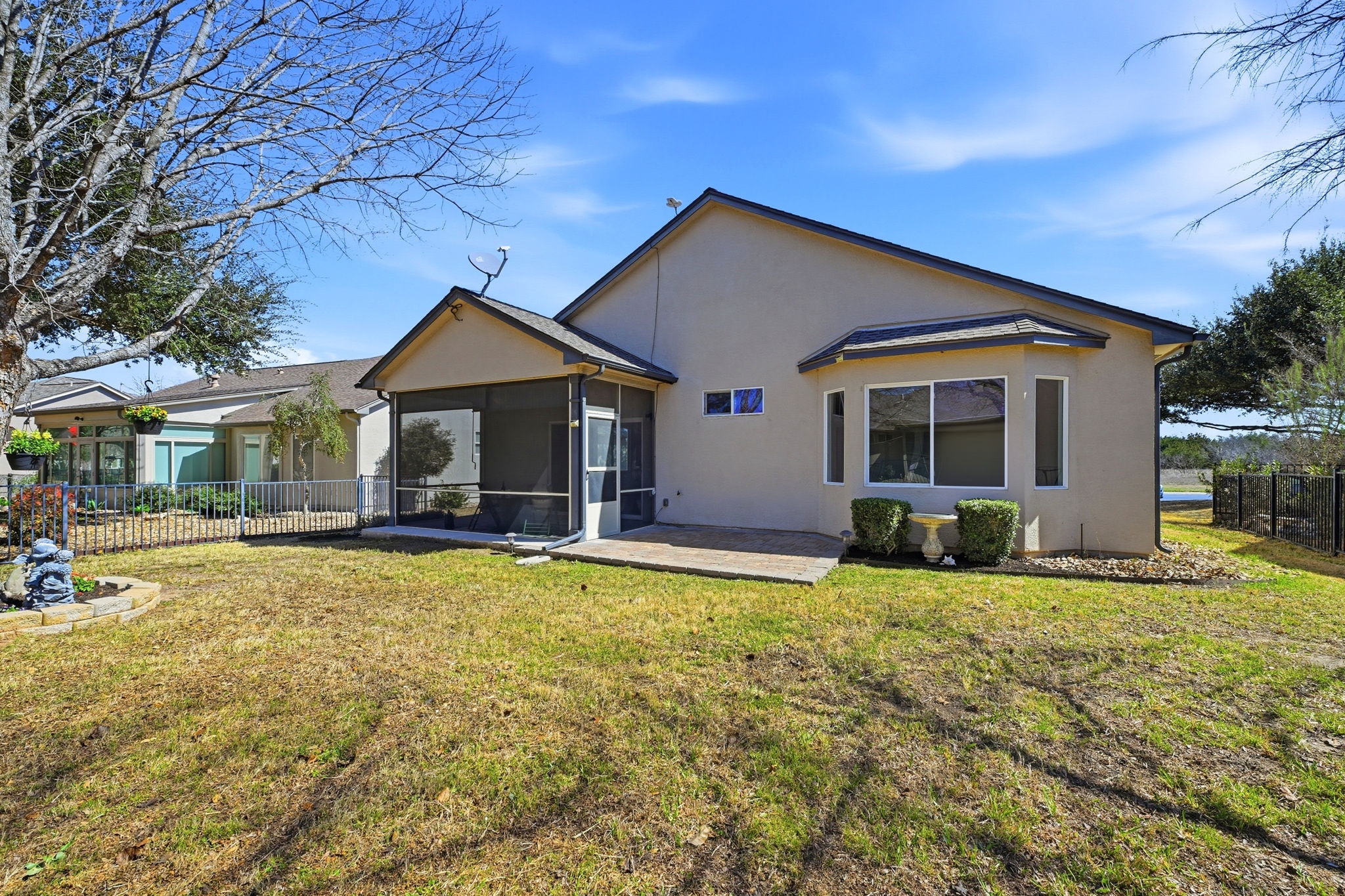 708 Texas Drive Georgetown, TX 78633 - Photo 26 of 27 Rear view of house with landscaping and sprinkler system.
