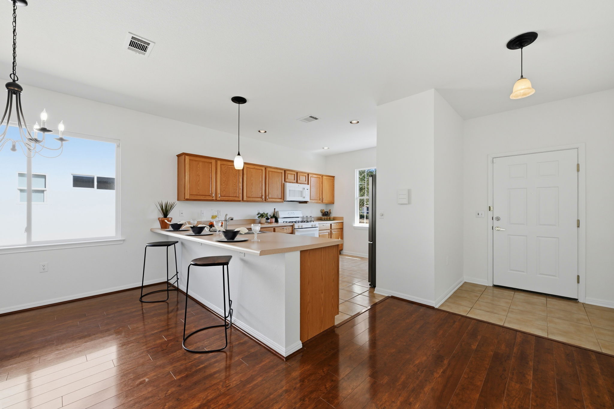 708 Texas Drive Georgetown, TX 78633 - Photo 6 of 27 Kitchen featuring light countertops and a breakfast bar.