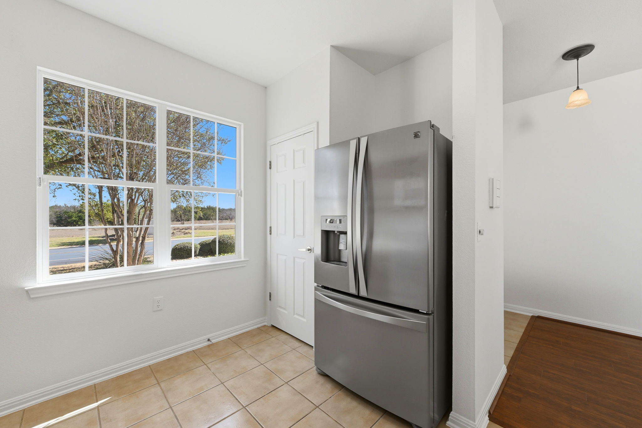 708 Texas Drive Georgetown, TX 78633 - Photo 8 of 27 Kitchen featuring stainless steel fridge with ice dispenser, light tile patterned flooring.