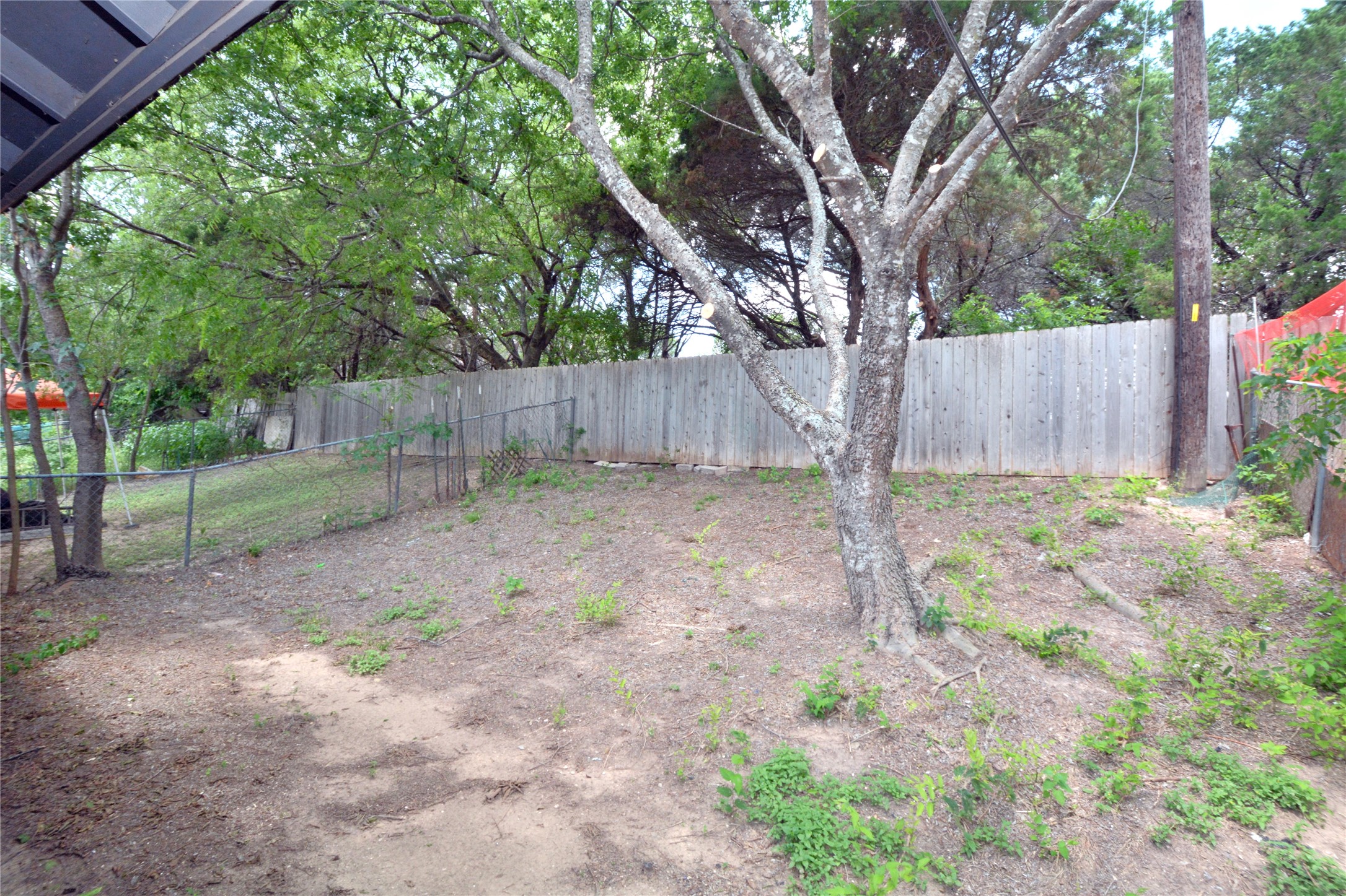 11314 Walnut Ridge Drive, Unit B Austin, TX 78753 - Photo 18 of 19 A secluded yard with mature trees and privacy fencing defines outdoor living possibilities.