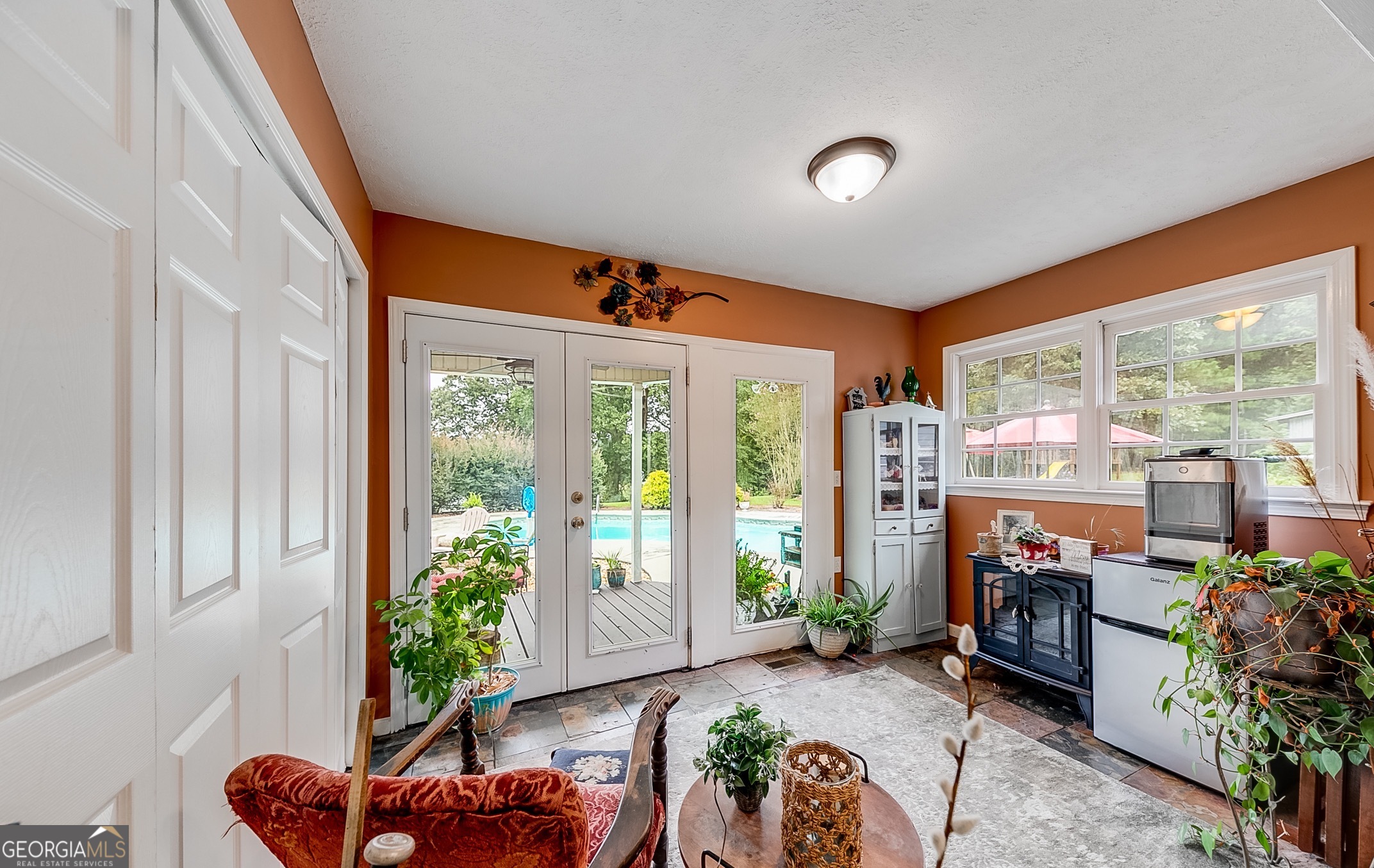 119 Yarbrough Ridgeway Road Commerce, GA 30529 - Photo 15 of 50 a living room with furniture a floor to ceiling window and potted plants