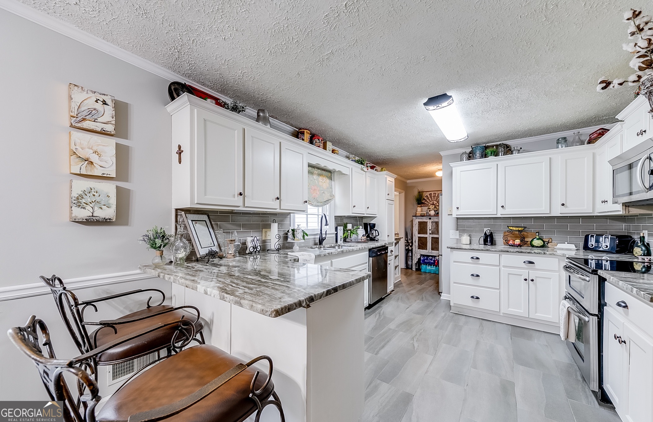 119 Yarbrough Ridgeway Road Commerce, GA 30529 - Photo 5 of 50 a kitchen with granite countertop a stove sink and cabinets