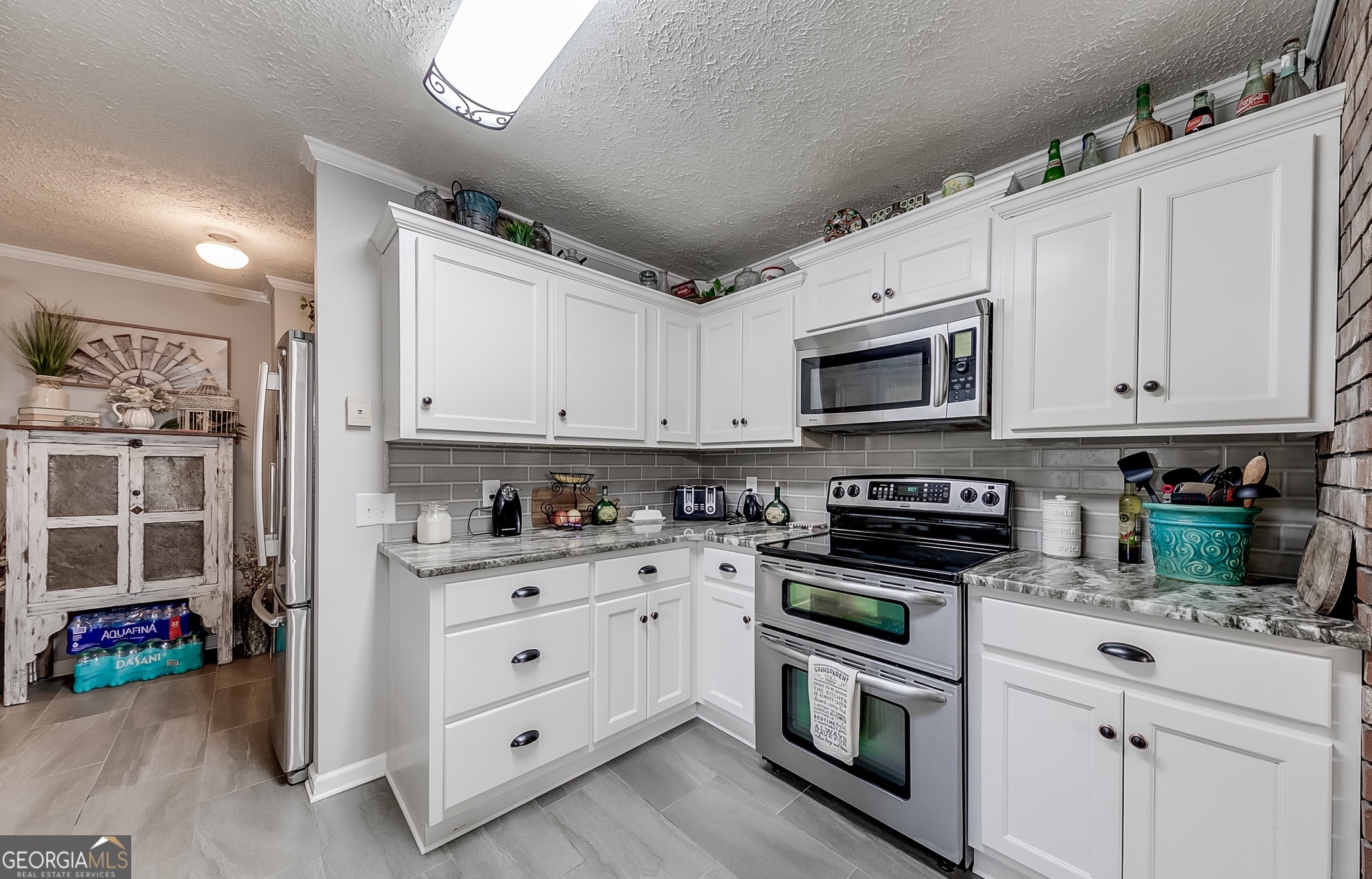 119 Yarbrough Ridgeway Road Commerce, GA 30529 - Photo 6 of 50 a kitchen with granite countertop white cabinets and stainless steel appliances