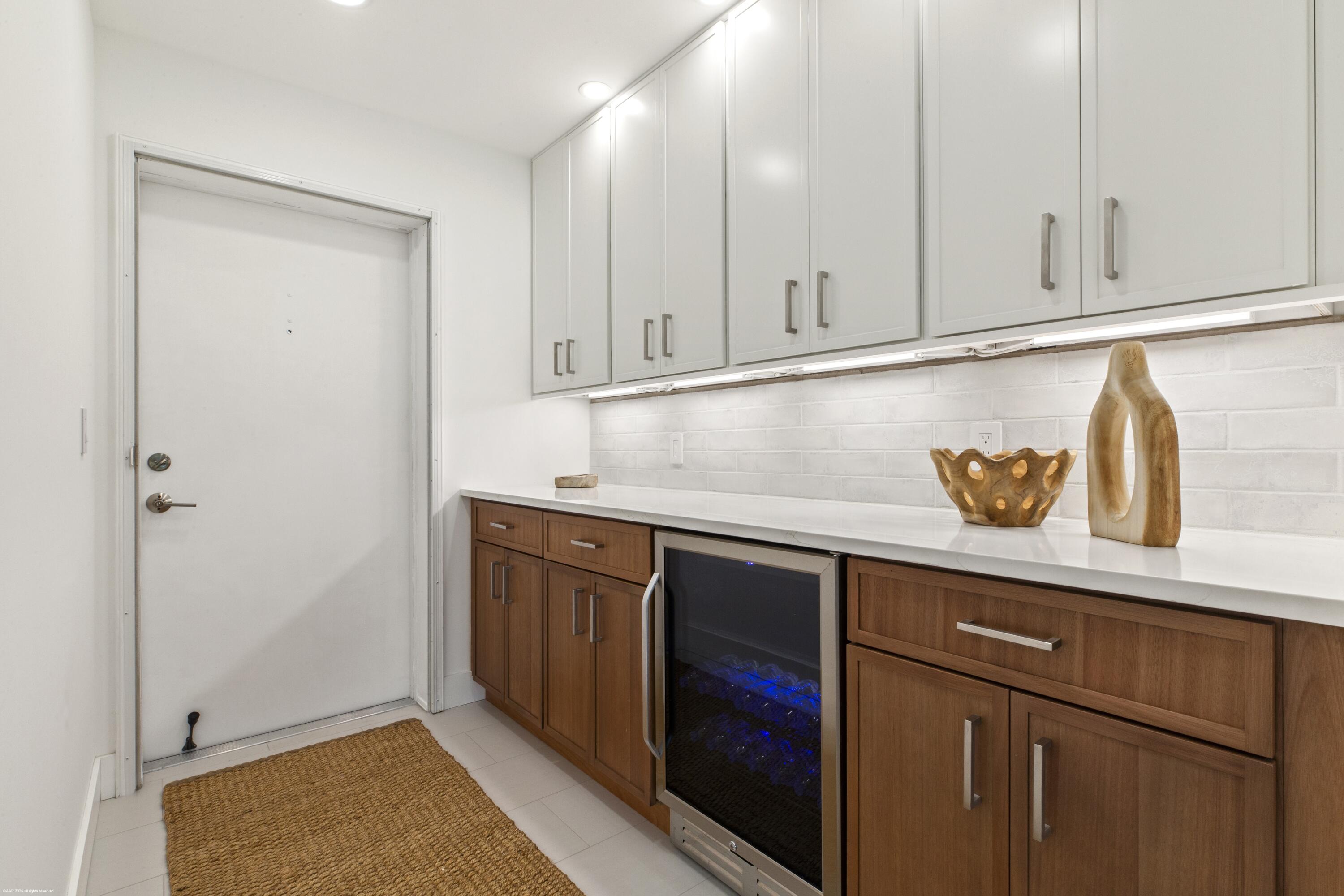 1030 Sugar Sands Boulevard, Unit 267 Singer Island, FL 33404 - Photo 13 of 51 a kitchen with granite countertop cabinets and white appliances