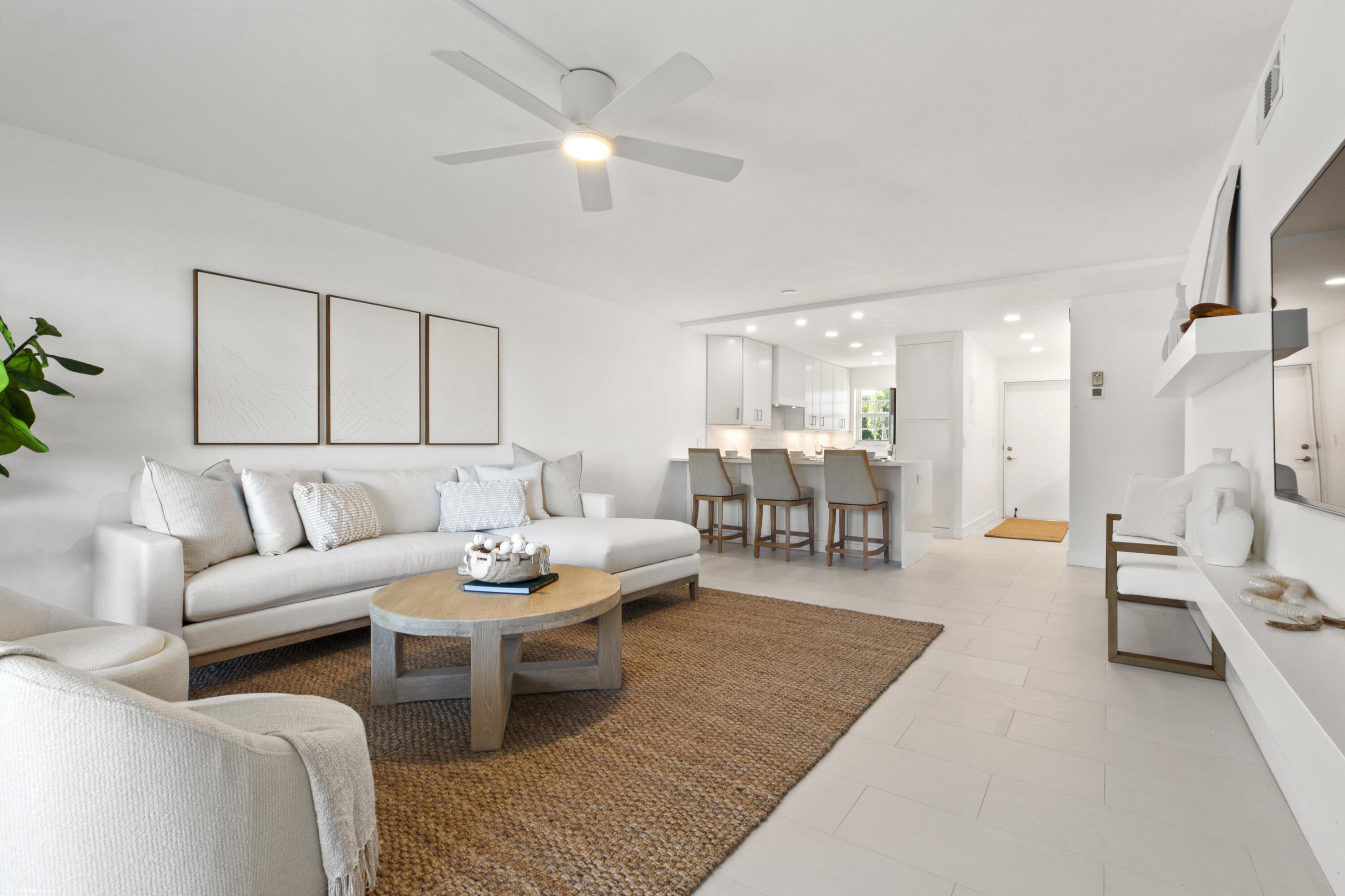 1030 Sugar Sands Boulevard, Unit 267 Singer Island, FL 33404 - Photo 18 of 51 a living room with furniture and a chandelier
