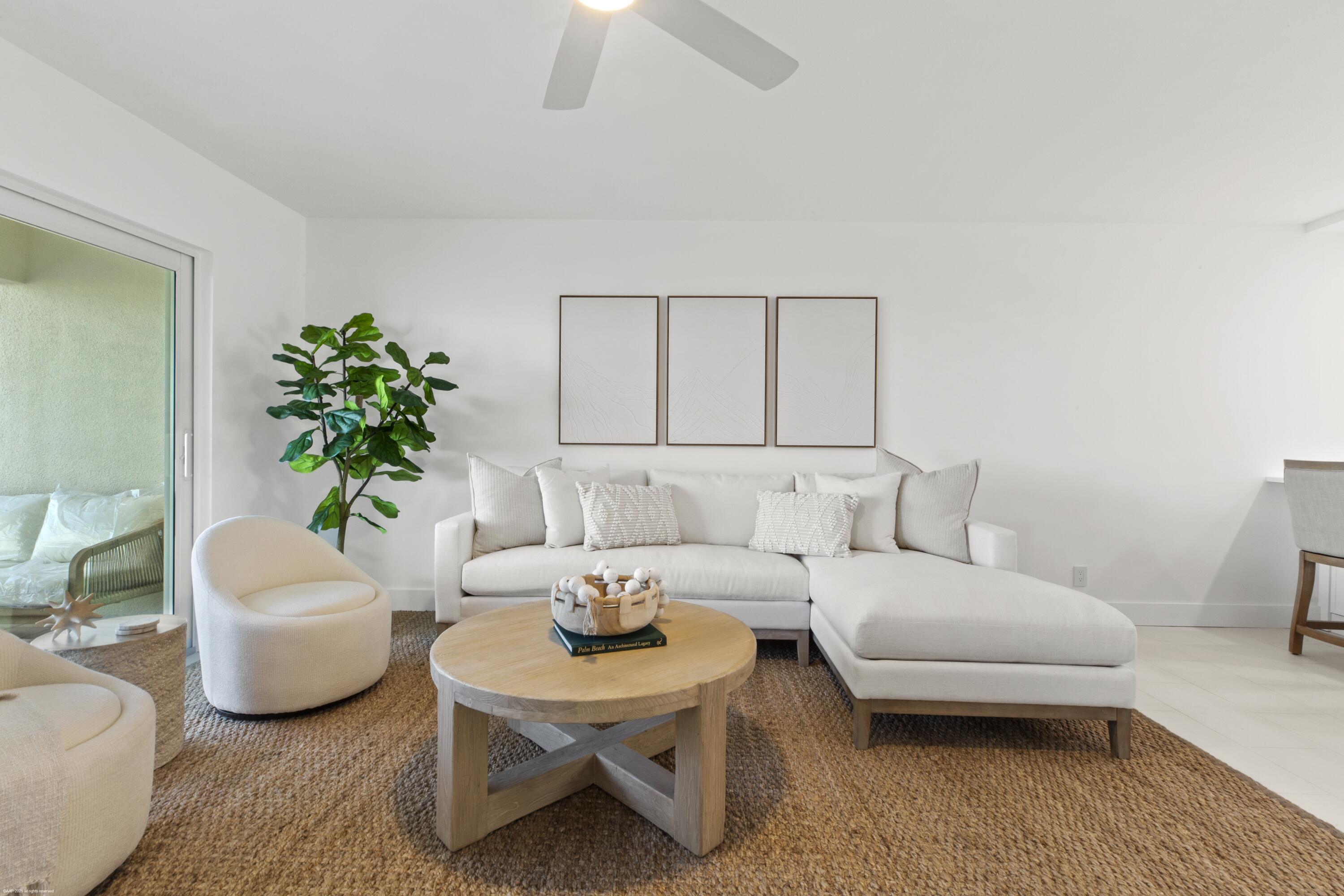 1030 Sugar Sands Boulevard, Unit 267 Singer Island, FL 33404 - Photo 19 of 51 a living room with furniture a couch and a potted plant
