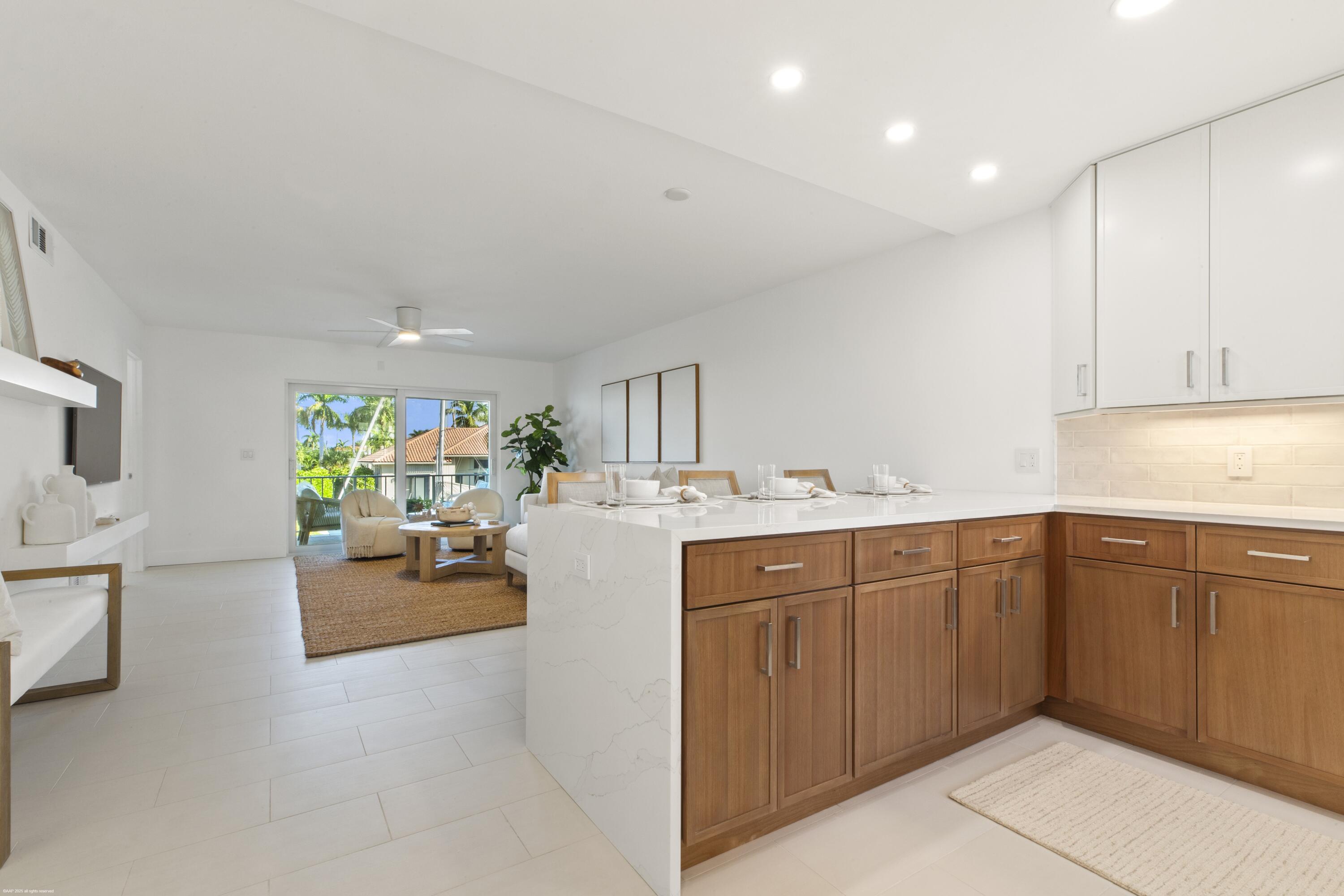 1030 Sugar Sands Boulevard, Unit 267 Singer Island, FL 33404 - Photo 20 of 51 a kitchen with sink and cabinets
