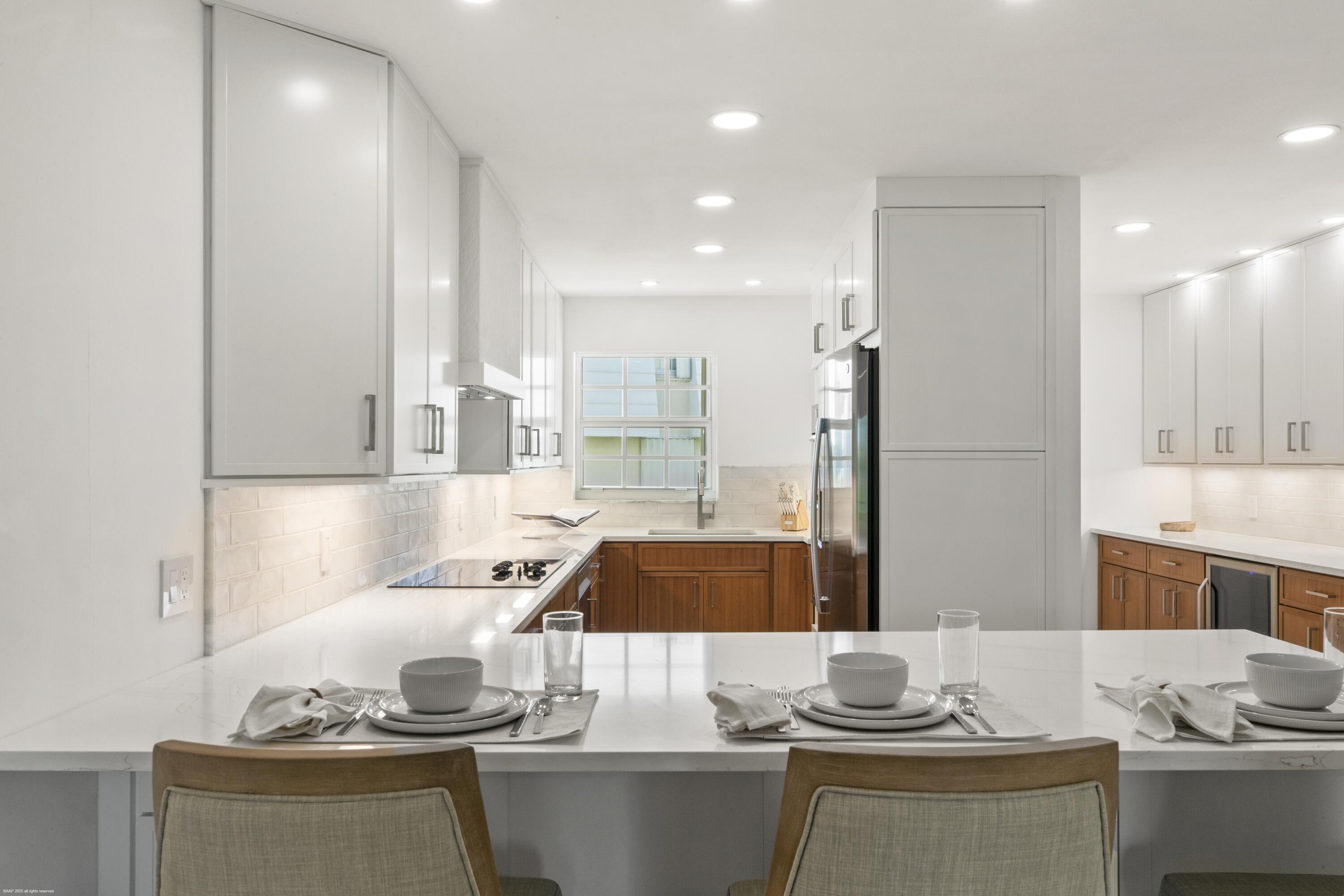 1030 Sugar Sands Boulevard, Unit 267 Singer Island, FL 33404 - Photo 22 of 51 a kitchen with a sink and cabinets