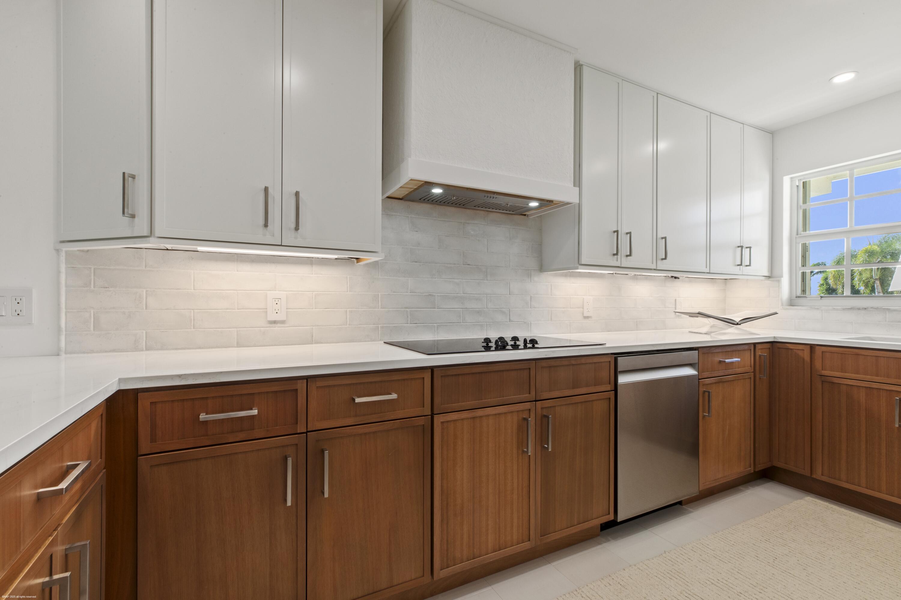 1030 Sugar Sands Boulevard, Unit 267 Singer Island, FL 33404 - Photo 23 of 51 a kitchen with granite countertop cabinets stainless steel appliances and sink