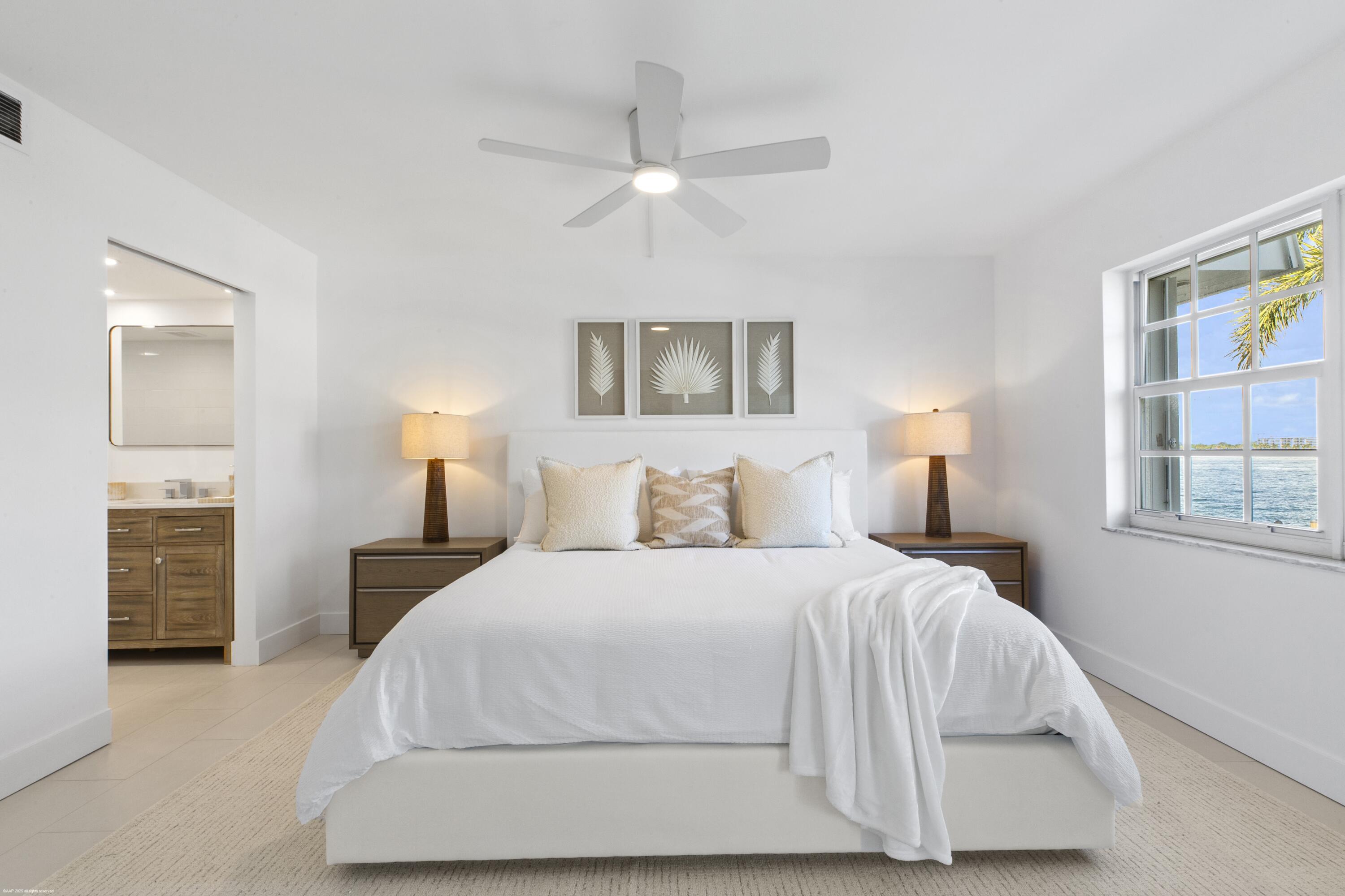 1030 Sugar Sands Boulevard, Unit 267 Singer Island, FL 33404 - Photo 25 of 51 a bedroom with a bed and a night stand