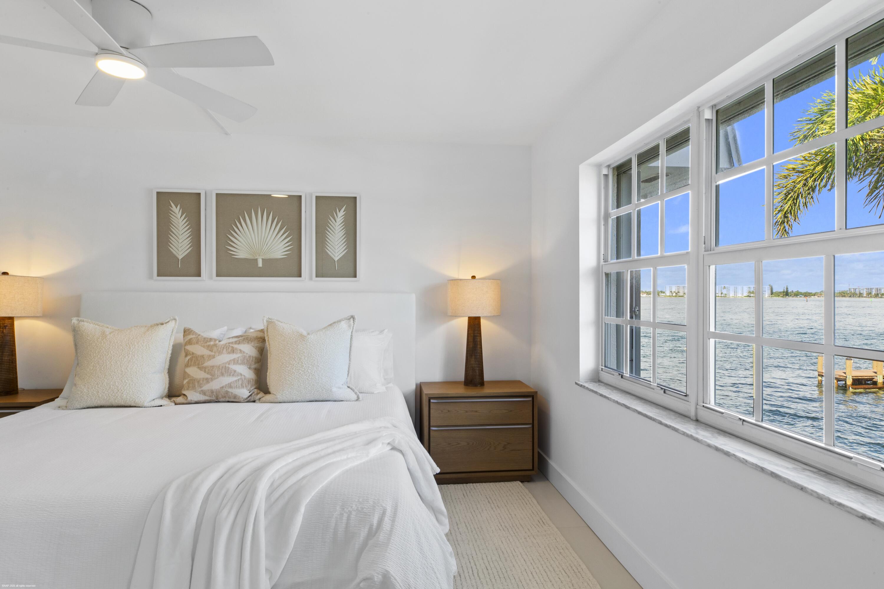 1030 Sugar Sands Boulevard, Unit 267 Singer Island, FL 33404 - Photo 27 of 51 a bedroom with a bed and a large window