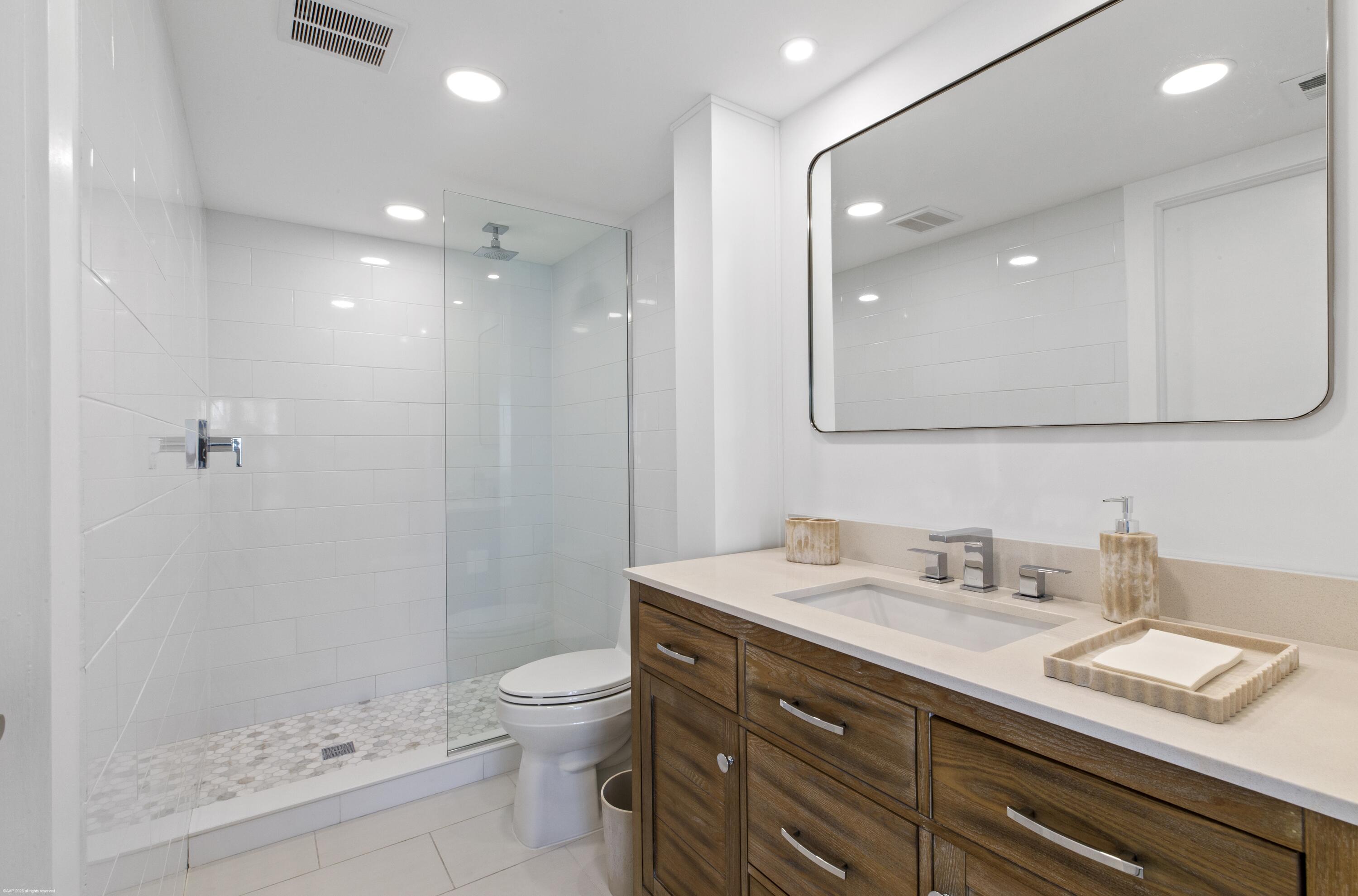 1030 Sugar Sands Boulevard, Unit 267 Singer Island, FL 33404 - Photo 28 of 51 a bathroom with a sink a toilet and shower