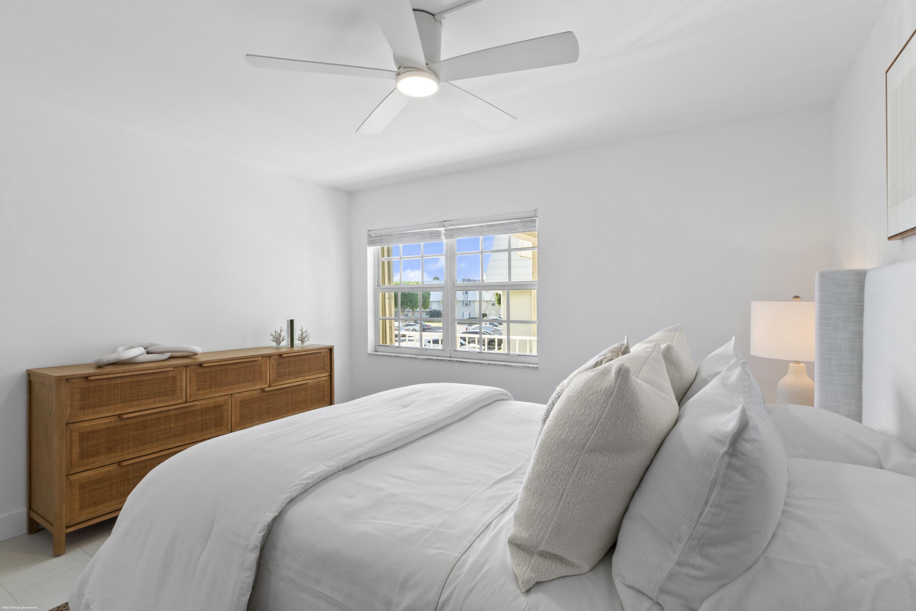 1030 Sugar Sands Boulevard, Unit 267 Singer Island, FL 33404 - Photo 33 of 51 a bedroom with a bed and a window