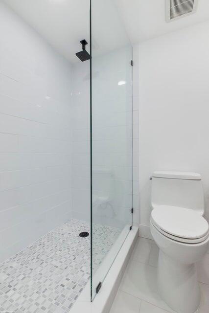 1030 Sugar Sands Boulevard, Unit 267 Singer Island, FL 33404 - Photo 35 of 51 a bathroom with a toilet and a shower