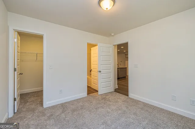 an empty room with closet and mirror