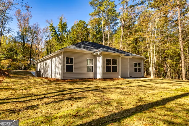 a yellow house with trees in front of it