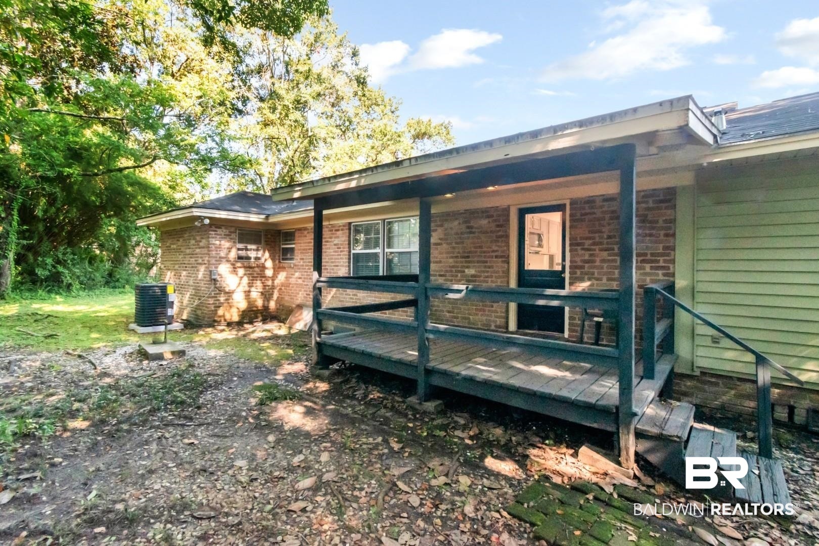 2105 Upham Court Mobile, AL 36607 - Photo 27 of 32 View of property exterior featuring a wooden deck and brick siding