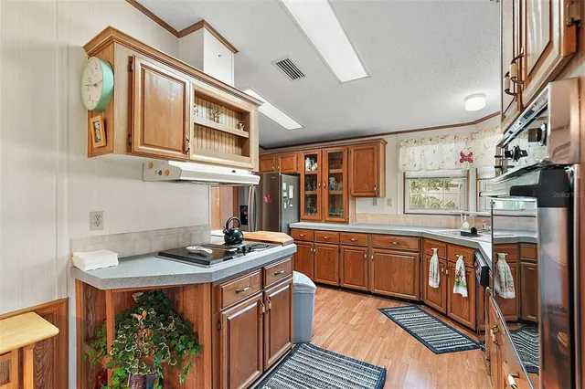 a kitchen with stainless steel appliances granite countertop a stove and a sink