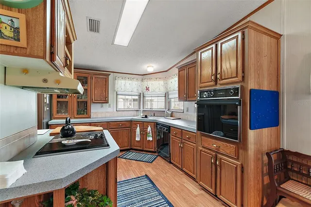 a kitchen with stainless steel appliances a sink stove and cabinets