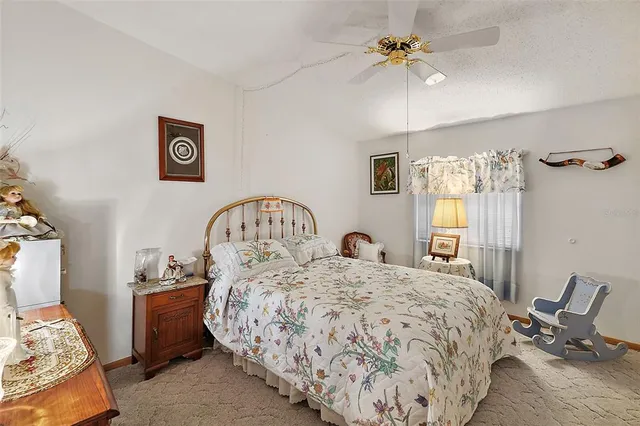 a spacious bedroom with a bed and a chandelier