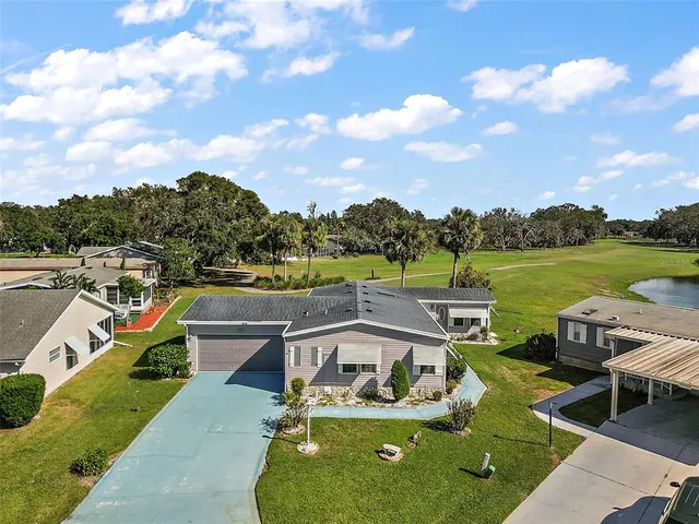 a view of a lake with couches in the patio