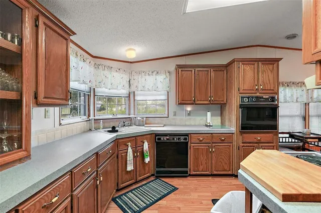 a kitchen with a sink stove and cabinets