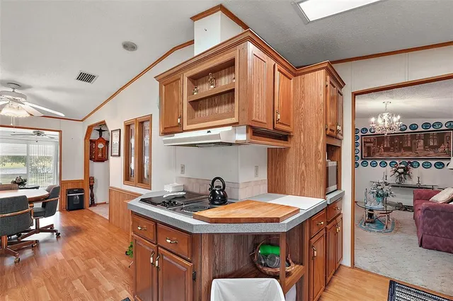 a kitchen with stainless steel appliances granite countertop a sink and a refrigerator