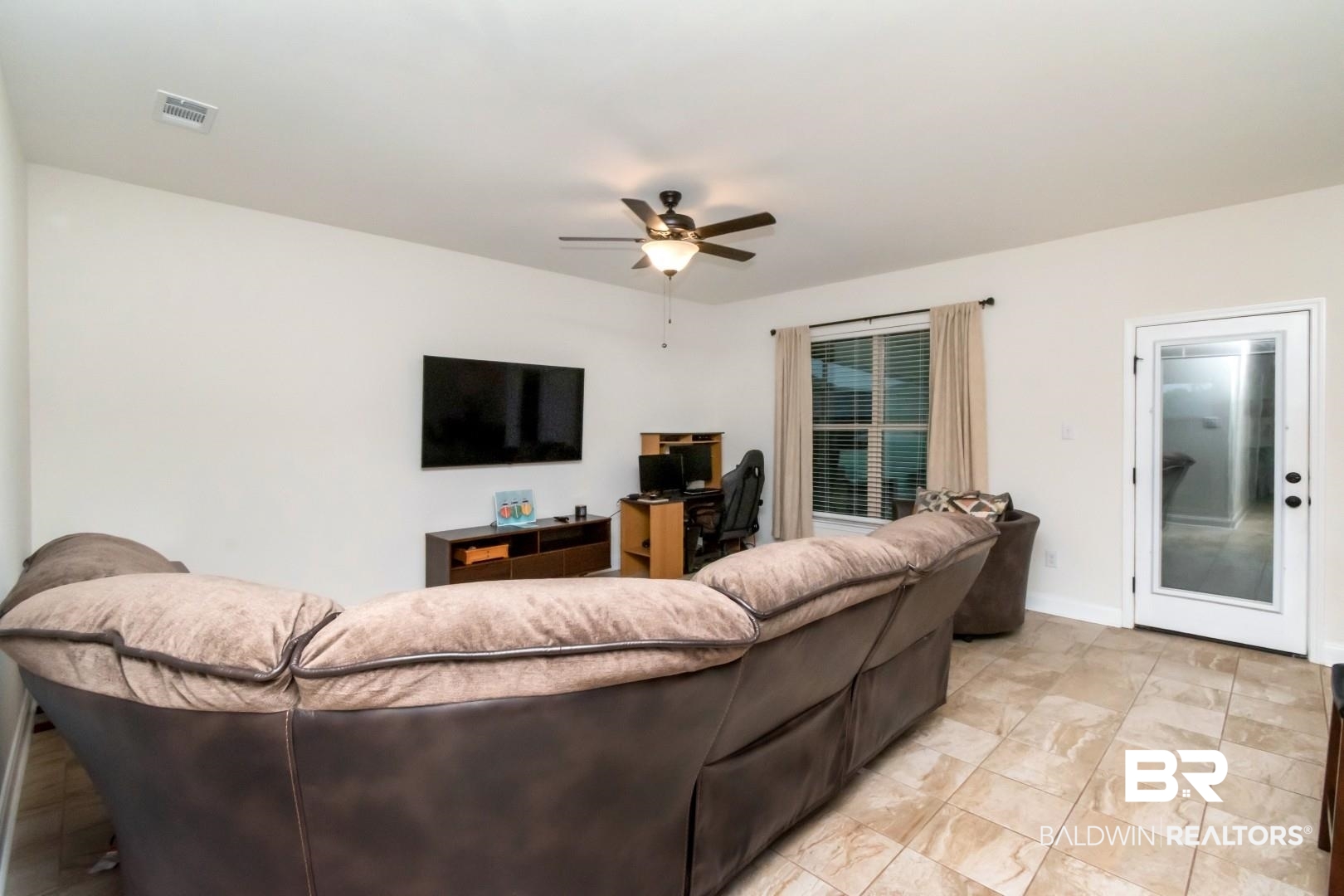 10714 Brodick Loop Spanish Fort, AL 36527 - Photo 13 of 26 Living area with a ceiling fan and a desk