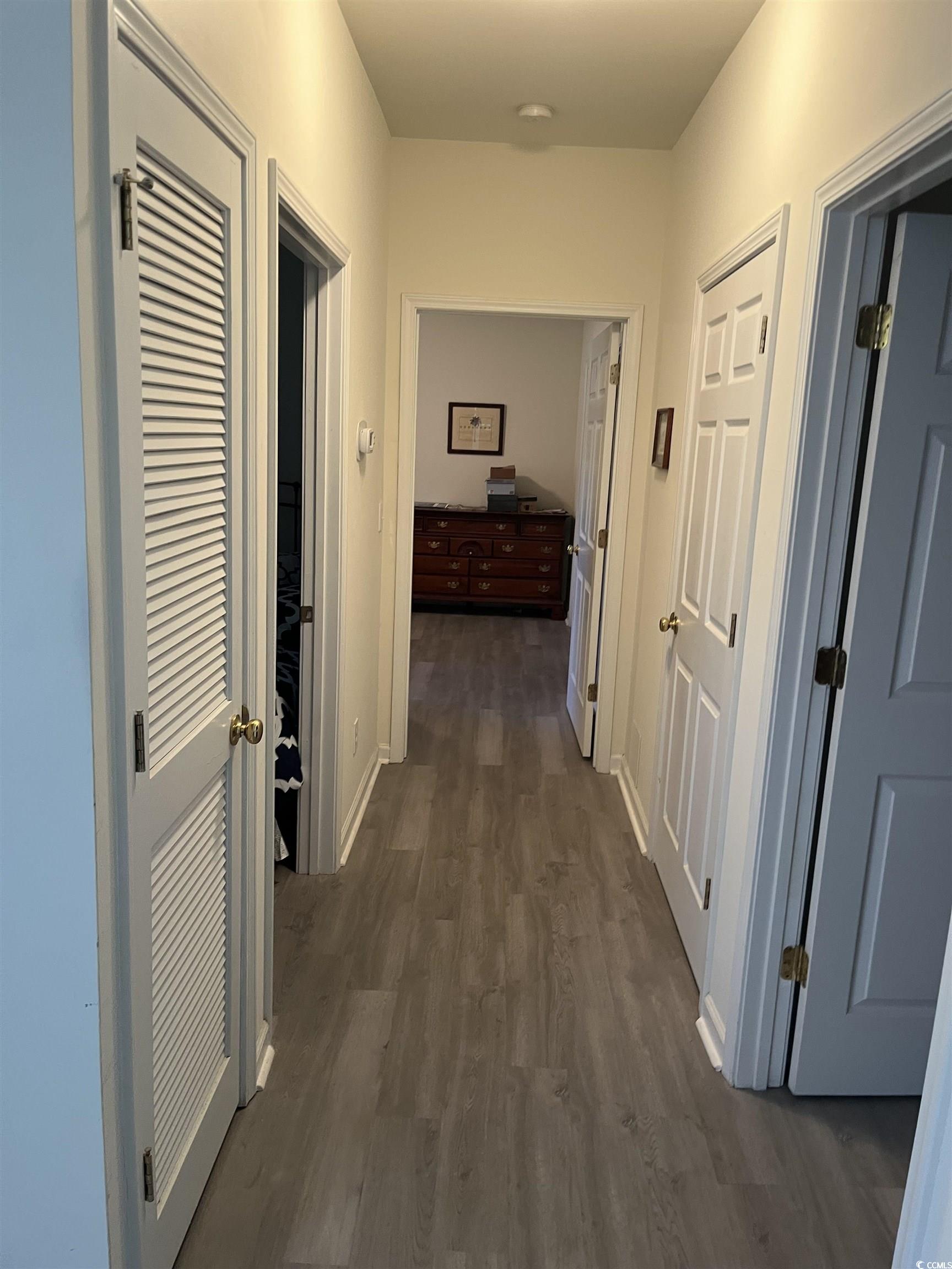 4430 Lady Banks Lane, Unit C1 Murrells Inlet, SC 29576 - Photo 14 of 34 Hallway featuring dark wood-type flooring and baseboards