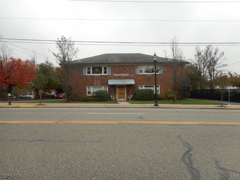 a front view of a building with a road