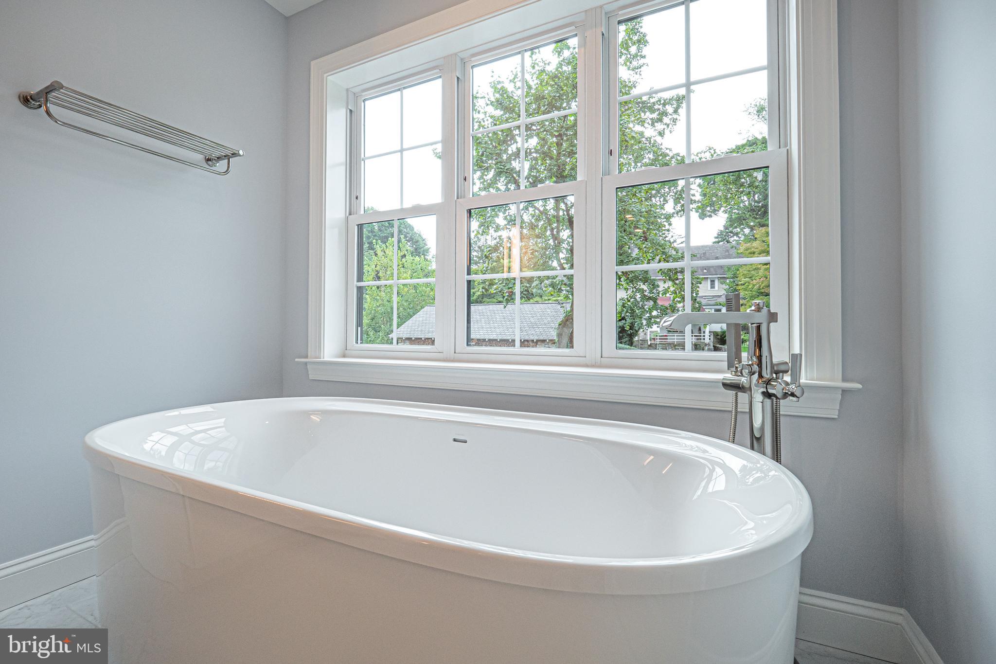 2 Timber Mill Lane, Unit SERENO Landenberg, PA 19350 - Photo 38 of 62 a white bath tub sitting in a bathroom next to a window