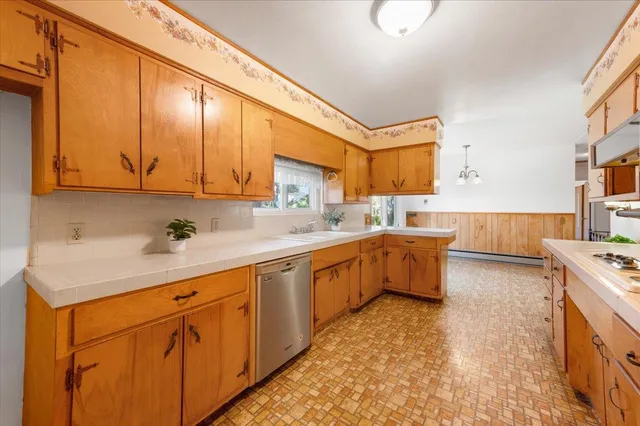 a bathroom with a toilet a sink a tub and mirror