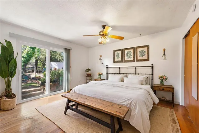a view of a patio with table and chairs potted plants and large tree