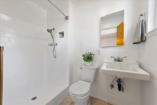 a view of backyard with wooden floor and fence