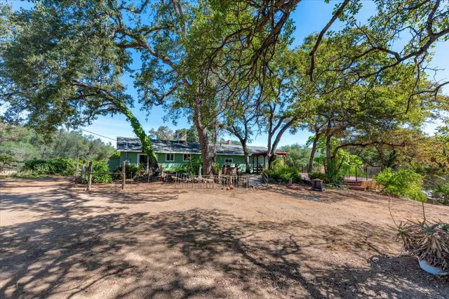 a view of a house with a yard and garage